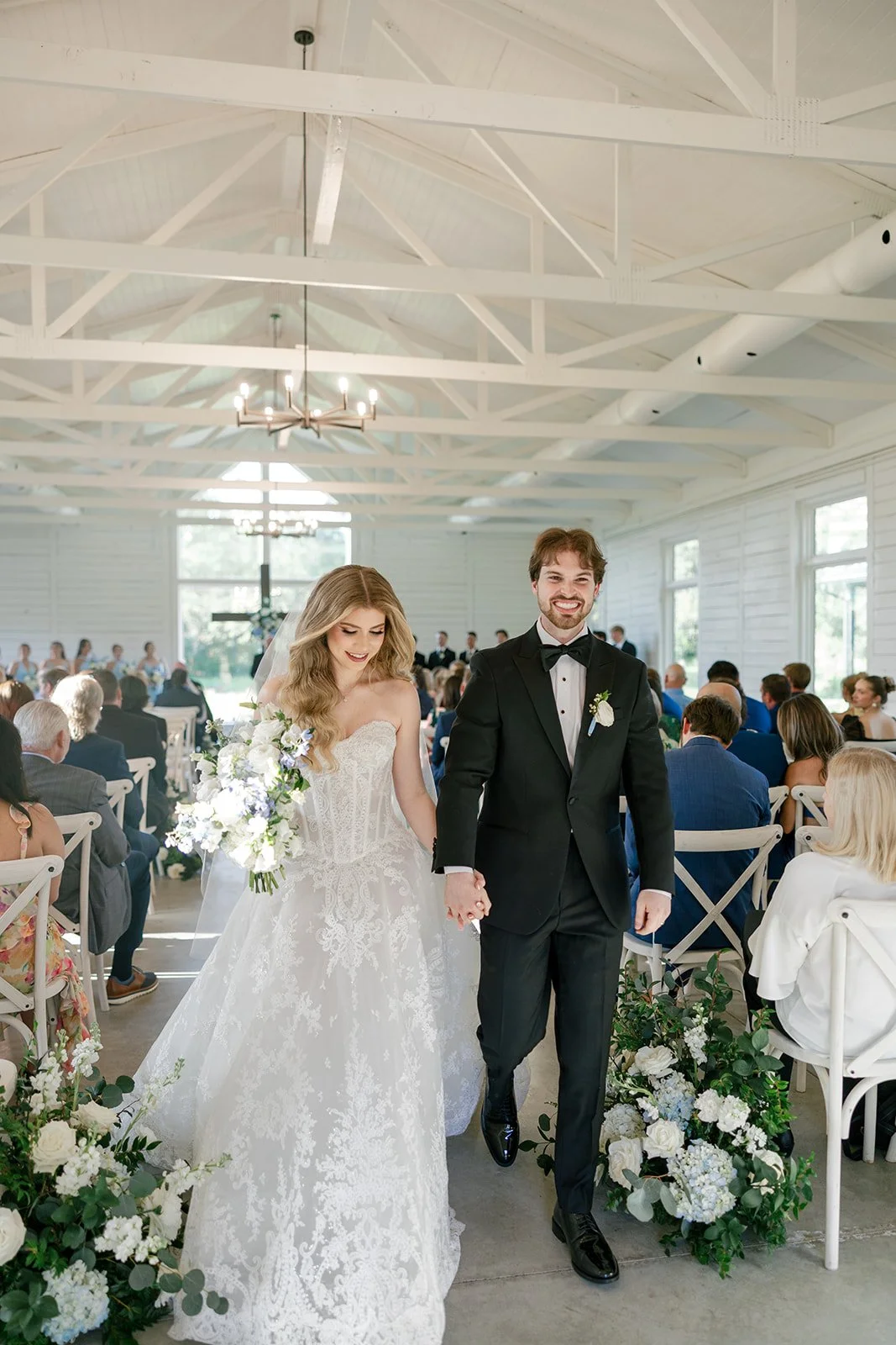 12-bride-and-groom-walking-back-up-the-aisle-of-the-white-chapel-at-the.jpg