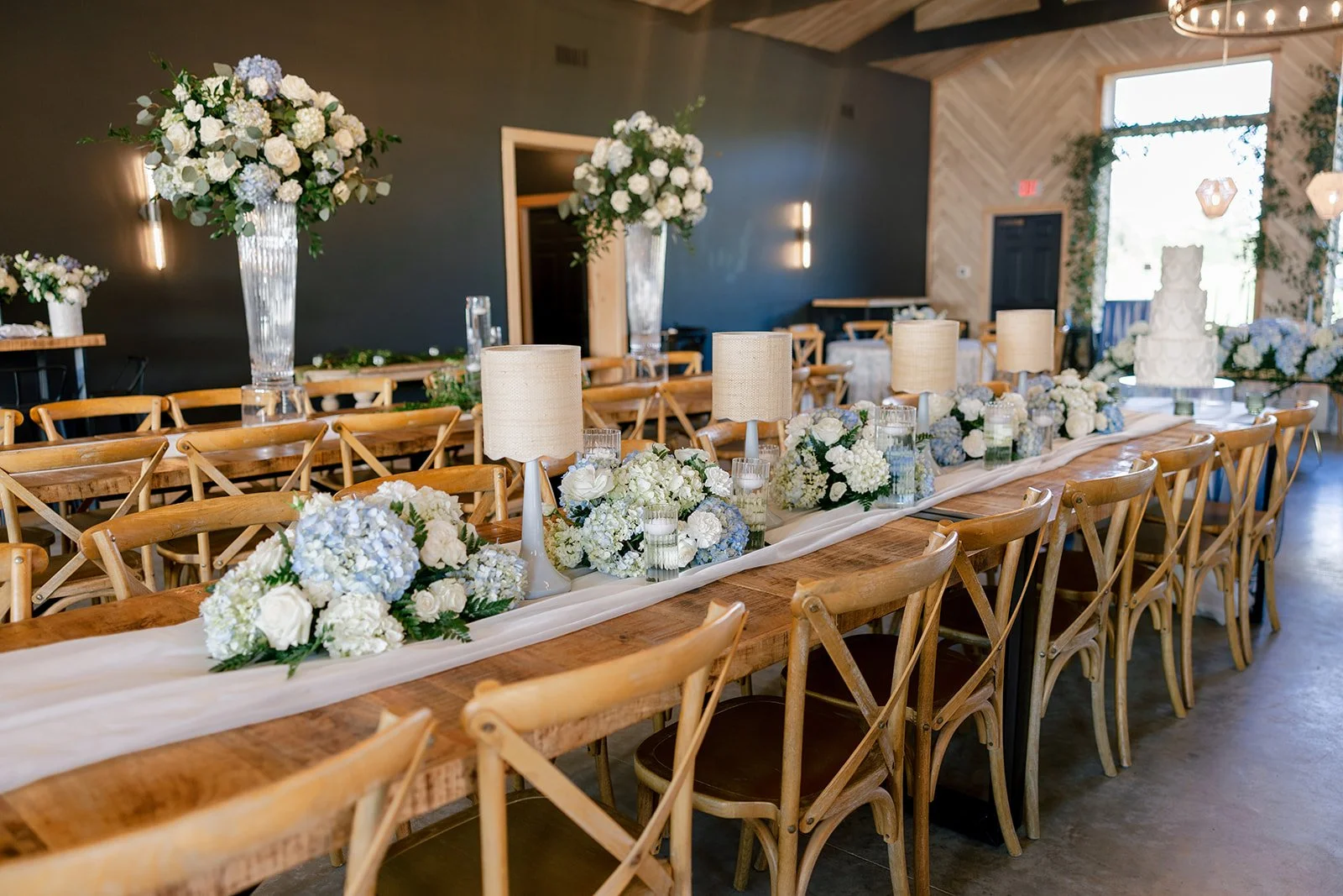13-farm-tables-with-table-lamps-blue-hydrangea-and-white-roses-at-a.jpg