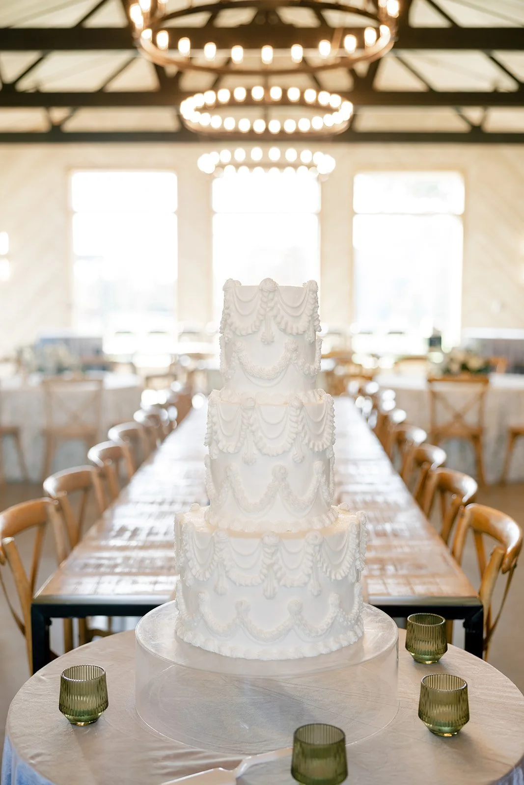 14-three-tier-white-wedding-cake-with-vintage-piped-swags-at-the-head-of-a.jpg
