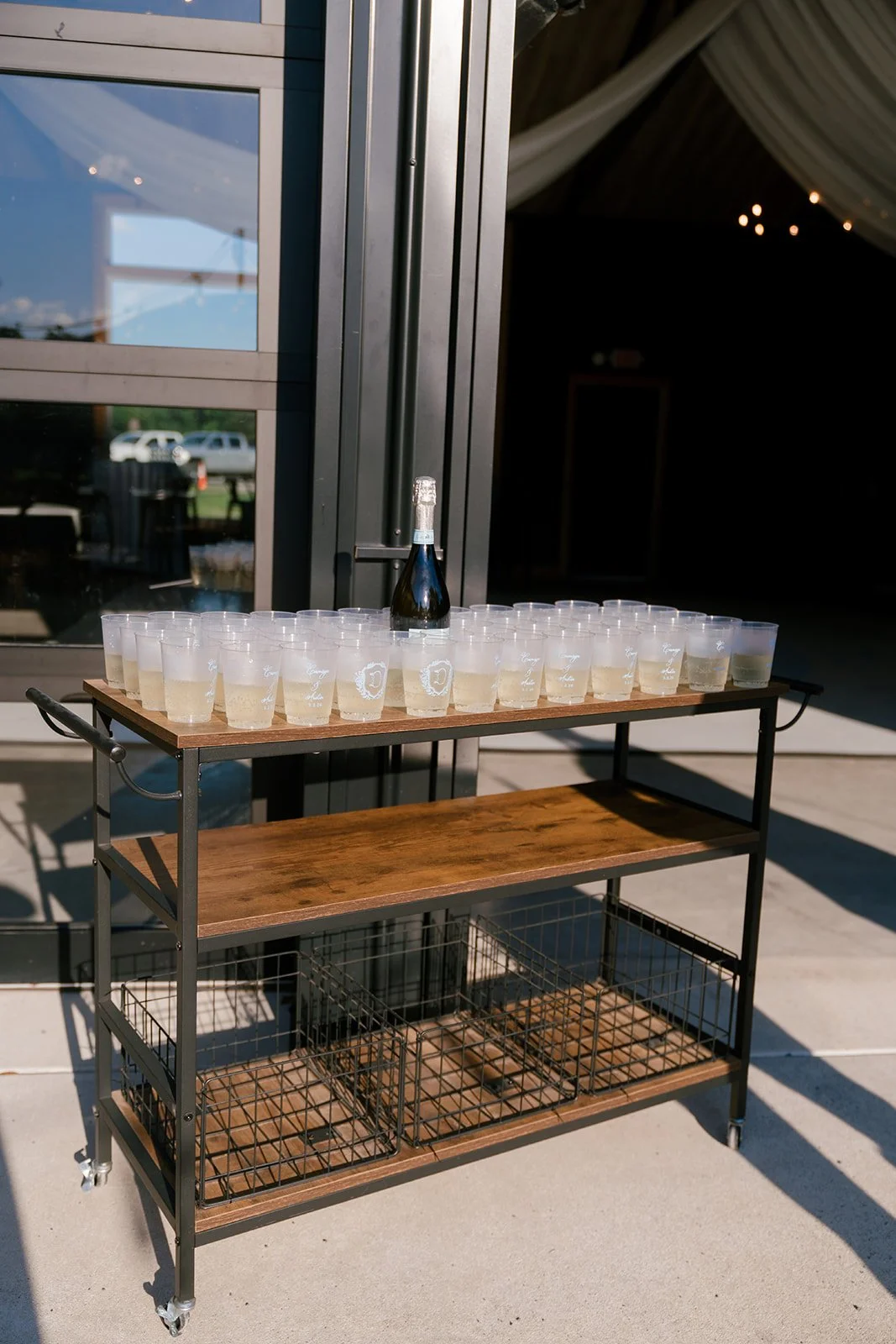 15-bar-cart-of-champagne-in-printed-cups-at-the-doors-of-the-stables-at.jpg