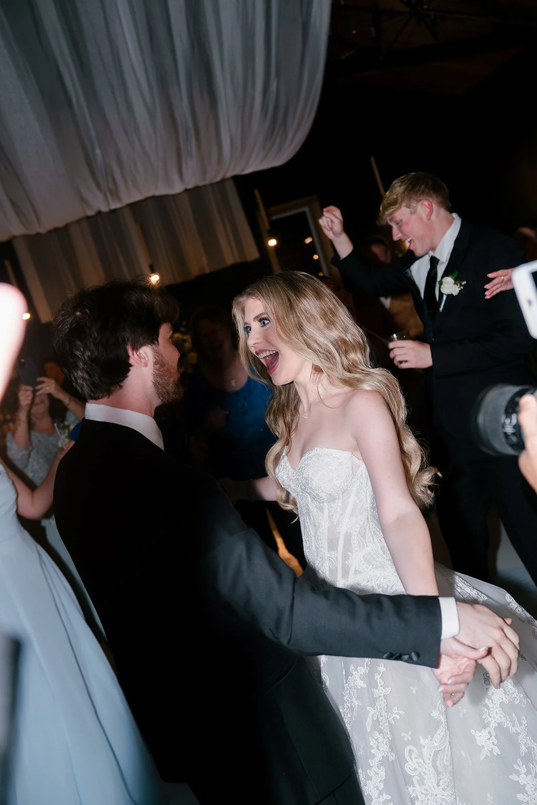 17-bride-and-groom-dancing-with-their-guests-under-draped-fabric-at-the.jpg