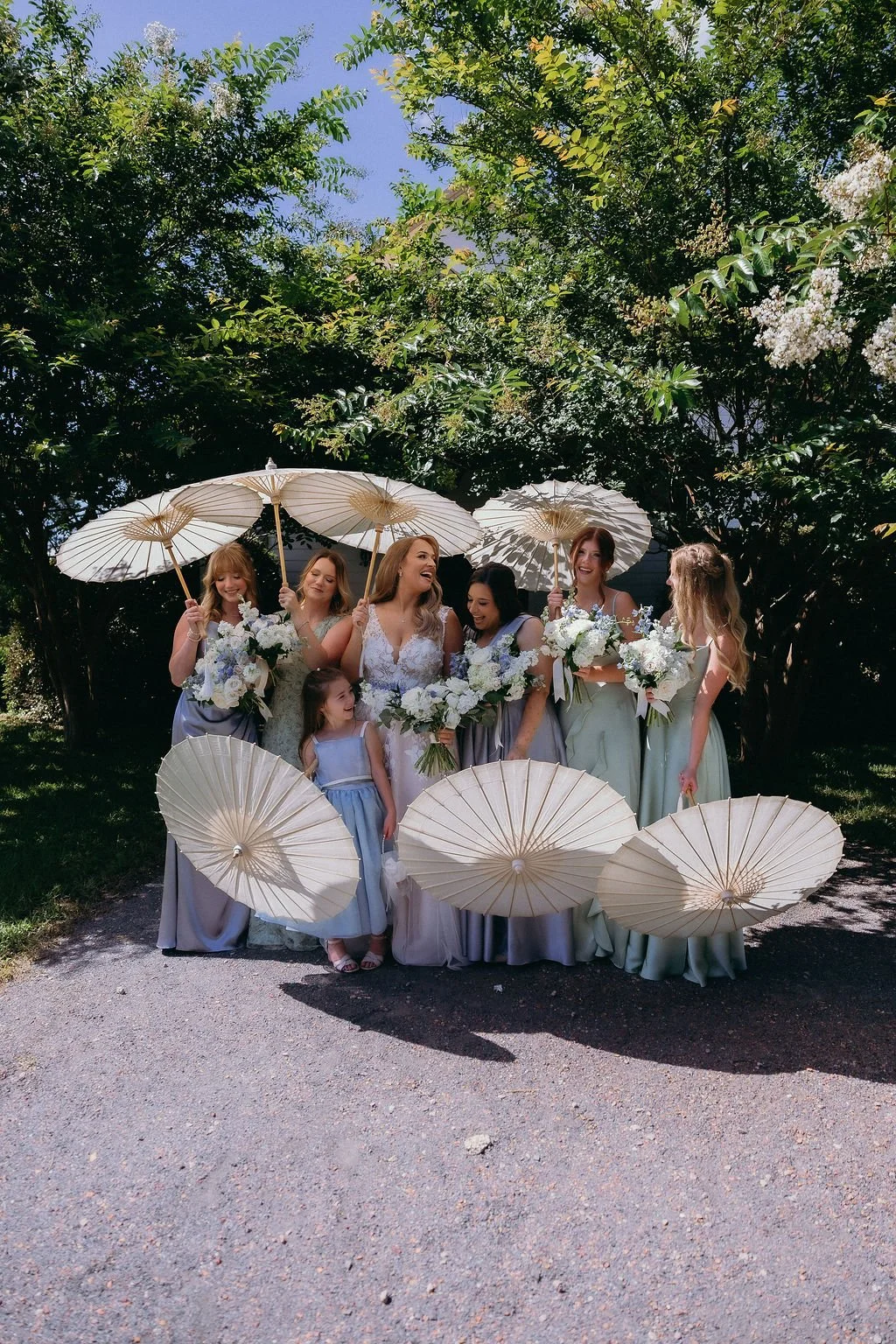 10-bride-and-bridesmaids-holding-white-paper-parasols-in-the-summer-sun-at.jpg