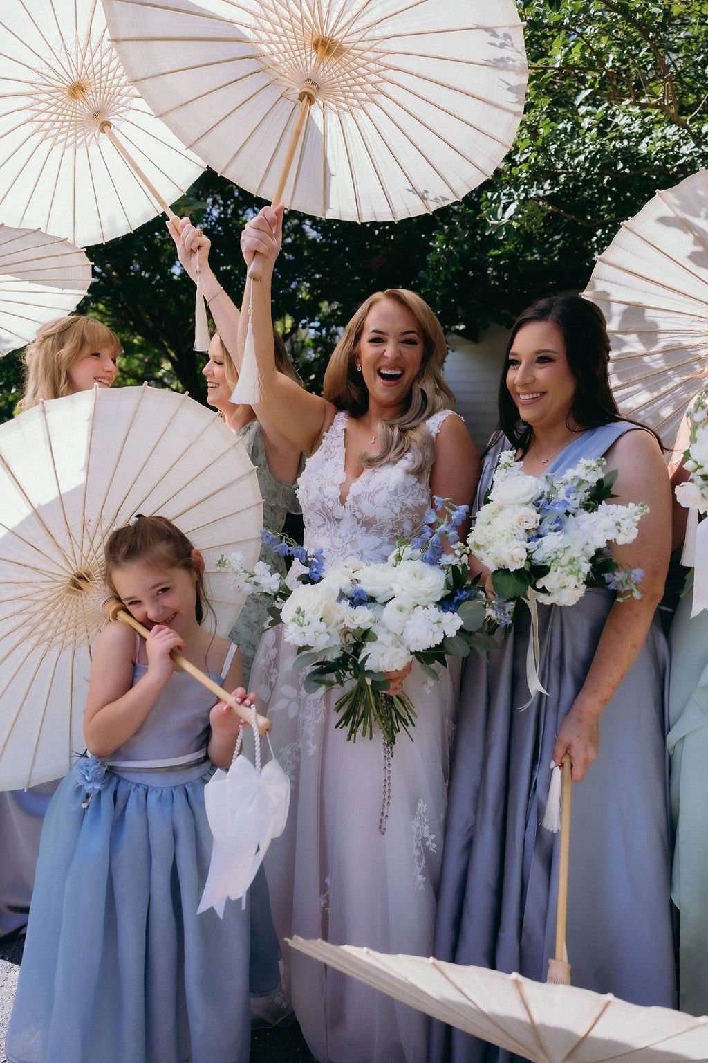 11-bride-laughing-under-paper-parasols-with-her-bridesmaids-and-flower.jpg