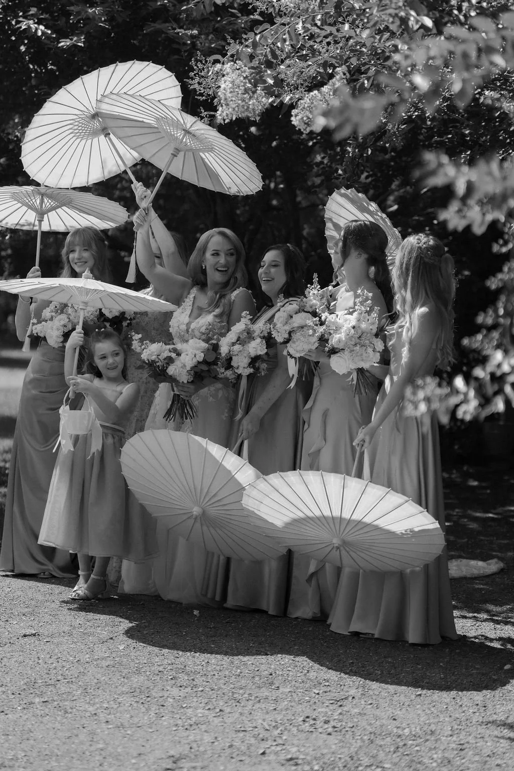 13-bridal-party-with-paper-parasols-in-black-and-white-at-the-stone-barn.jpg