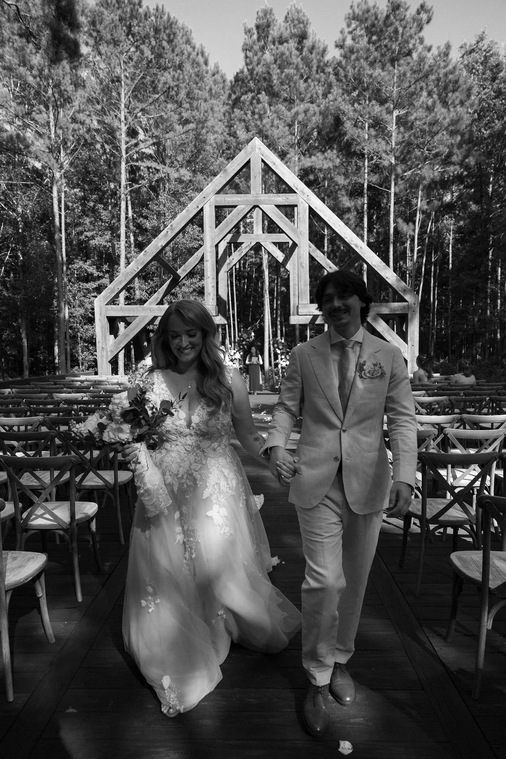 21-bride-and-groom-walking-back-up-the-aisle-of-the-sanctuary-in-the-pines.jpg