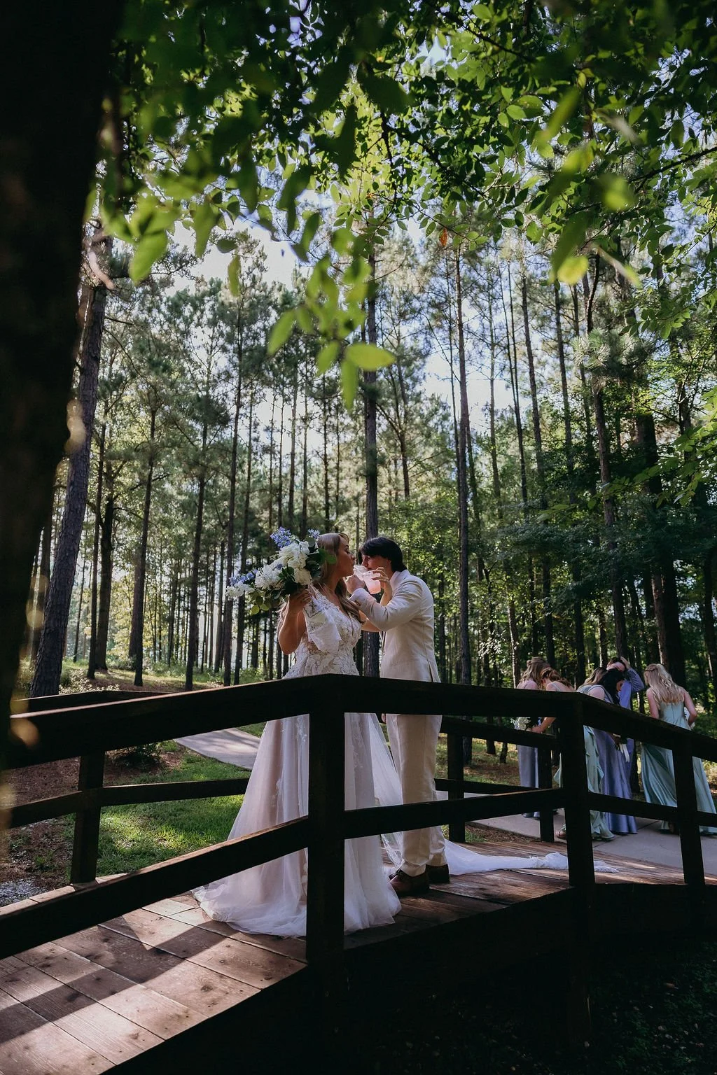 23-bride-and-groom-on-the-wooden-bridge-in-the-pines-at-the-stone-barn-at.jpg