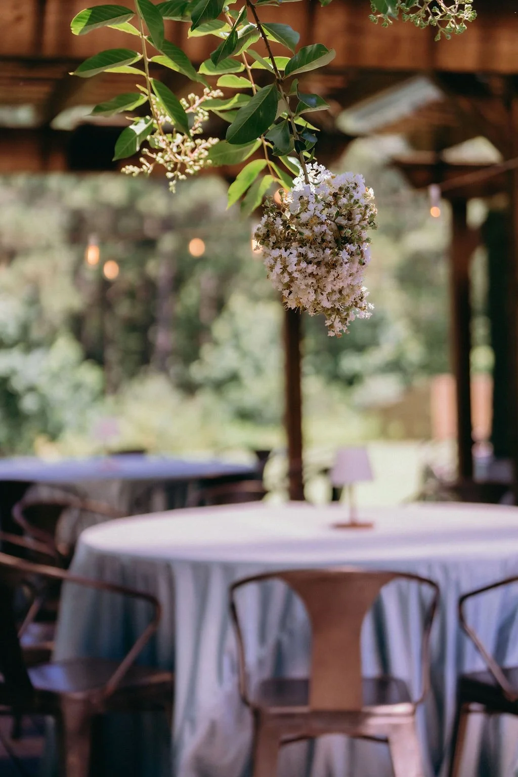 28-covered-patio-set-for-a-wedding-reception-beneath-blooming-crepe-myrtle.jpg