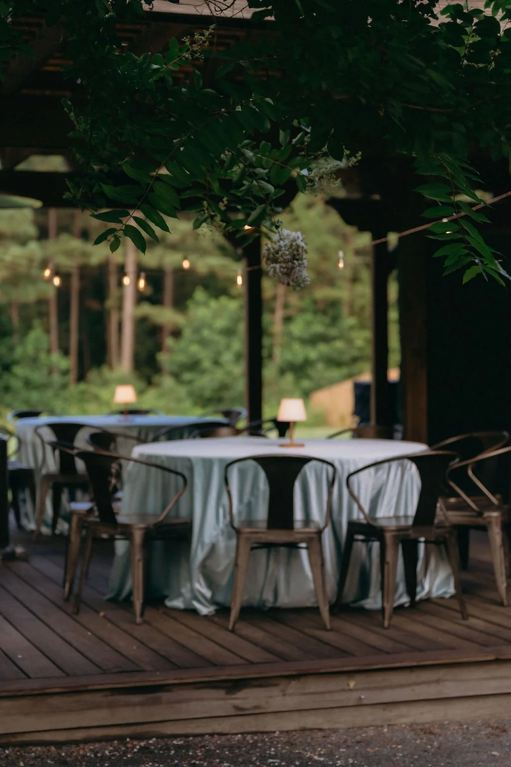29-patio-tables-with-linens-and-lamps-at-dusk-at-the-stone-barn-at-sainte.jpg