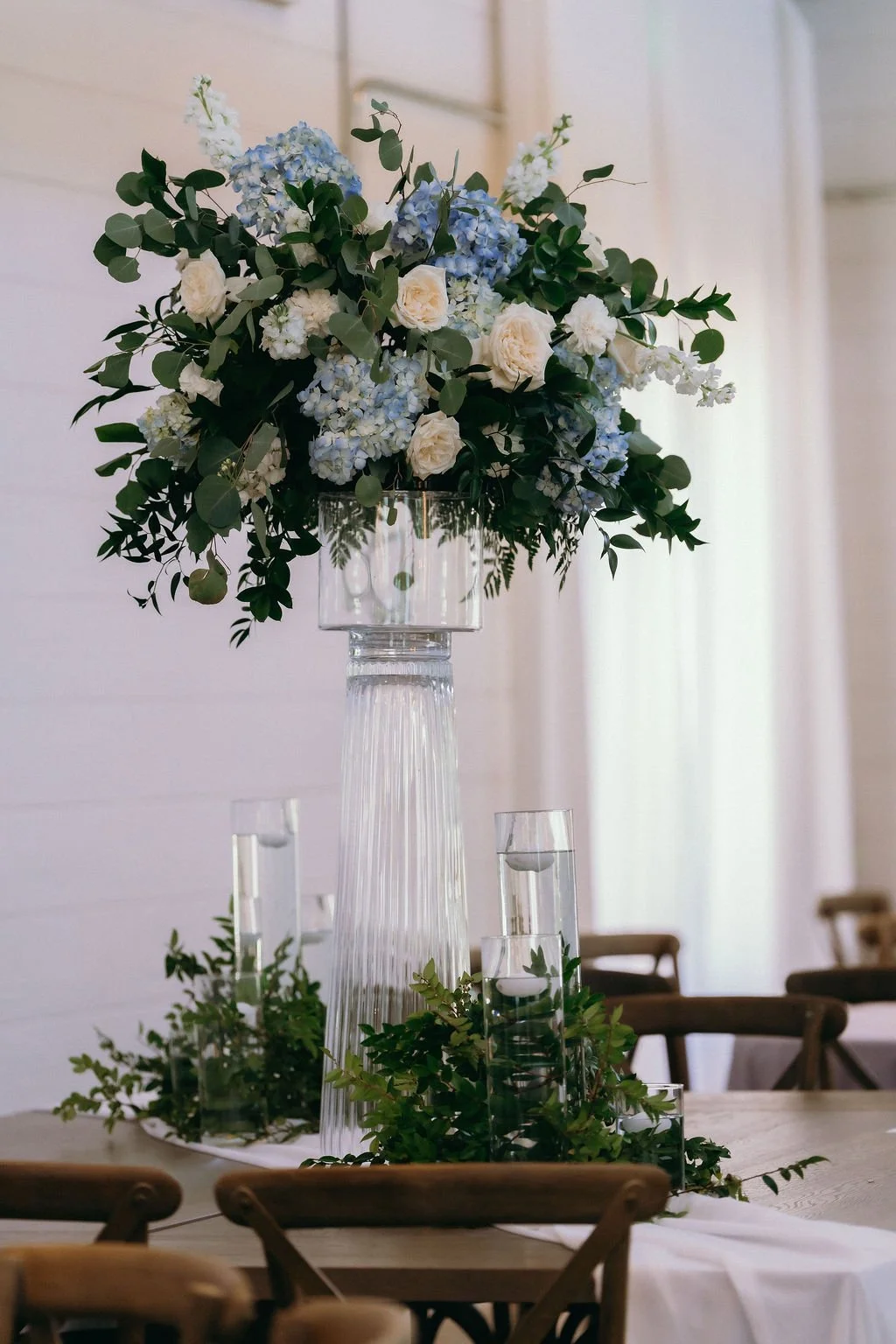 31-tall-blue-hydrangea-and-white-rose-centerpiece-on-glass-at-the-stone.jpg