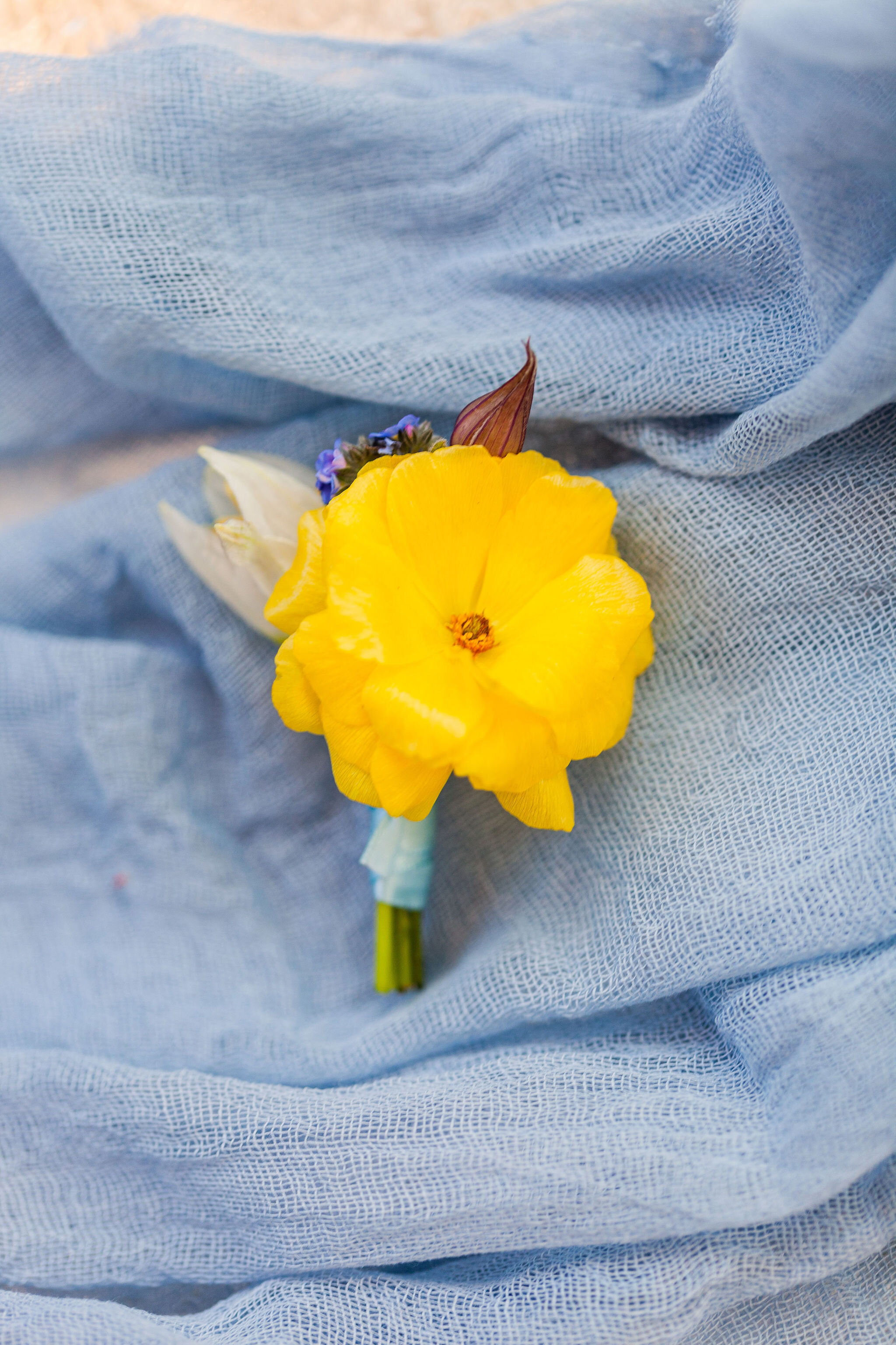 Spring Wedding Buttonholes: Yellow Butterfly Ranunculus, Frittilaria and Myosotis