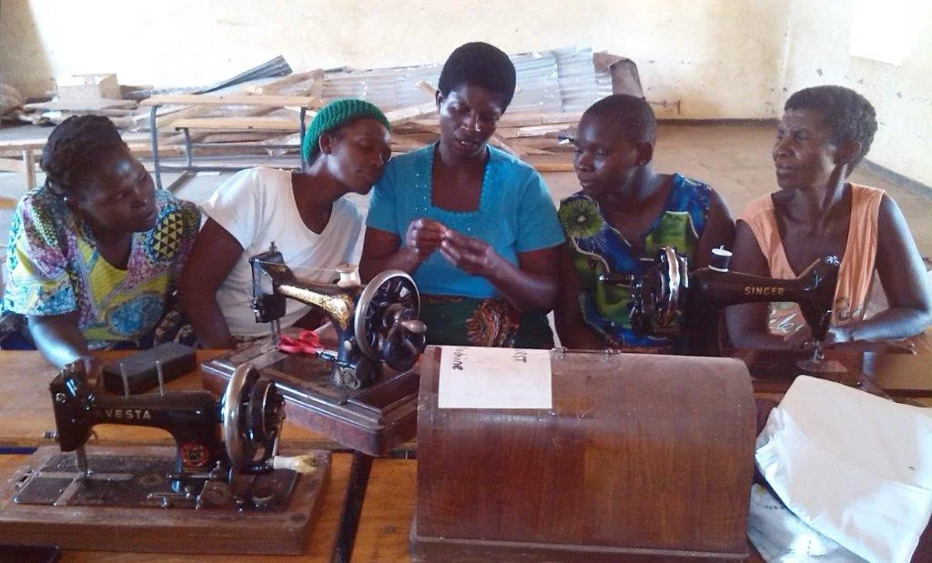 The ladies at Katitima learning how to sew and make the kits.