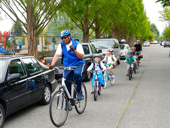 Loyal Heights Elementary principal Wayne Floyd leading a bike train, photo by Clint Loper .