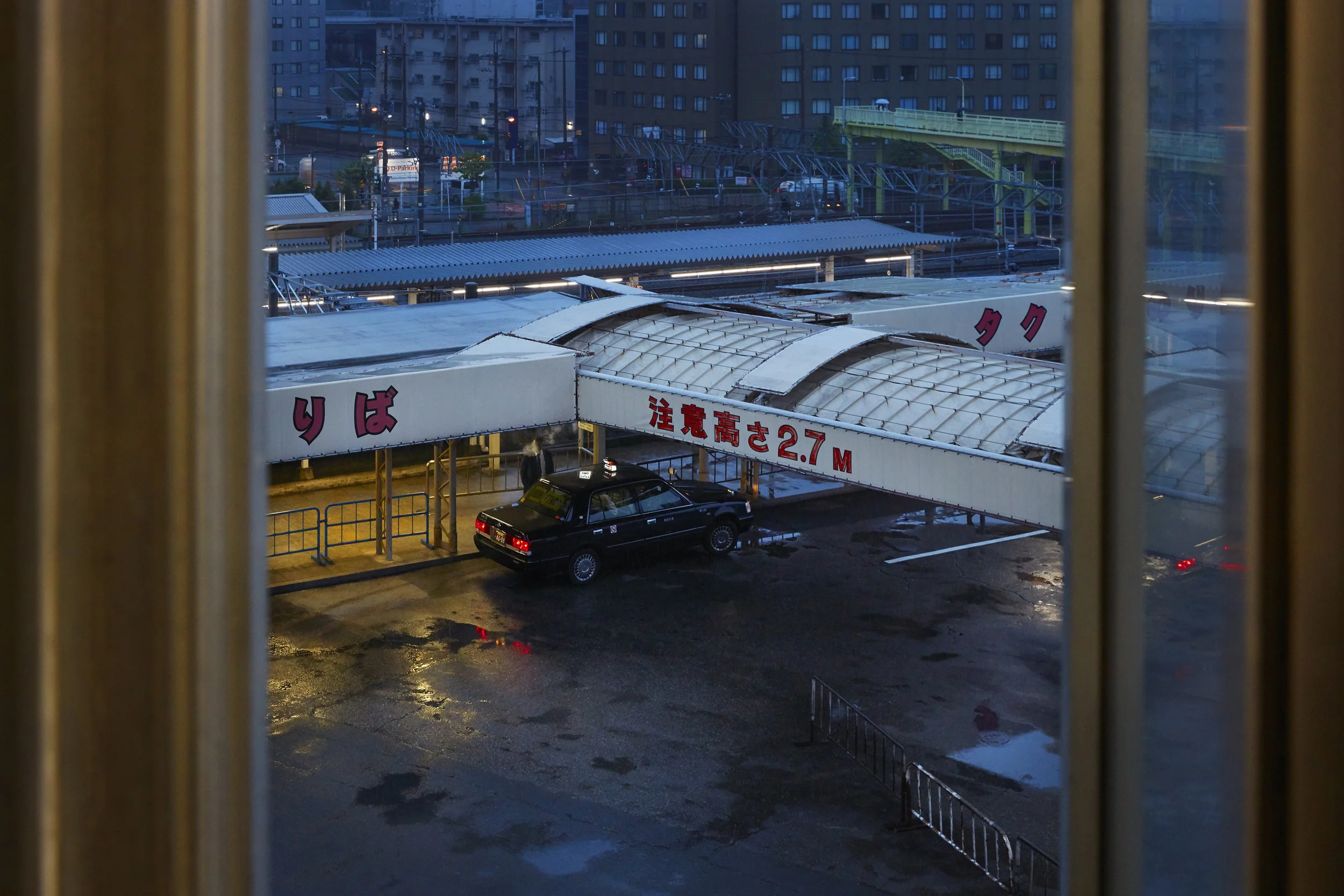 I was at Osaka station at 5:45am, whilist for my train to Okayama. I saw the taxi driver get out and light a cigarette, the smoke envelops his face, it looks like a scene from a japanese manga or a tarantino movie.