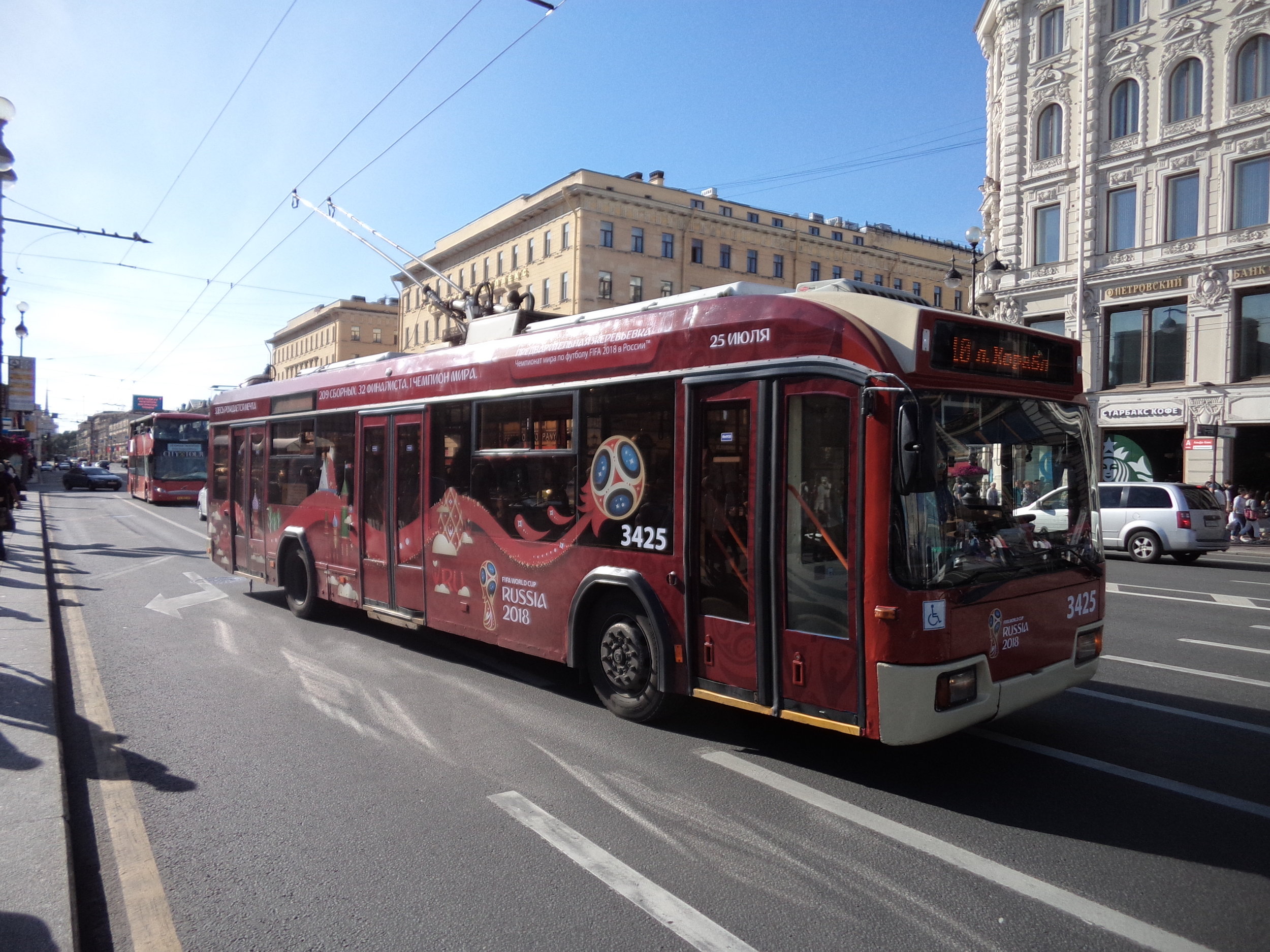 Flotila petrohradských trolejbusů postupně stárne. I přes snahu o průběžnou obnovu jsou v provozu vozy staré i 30 let. Na snímku z roku 2015 lze vidět vůz typu BKM 321 ev. č. 3425 (r. v. 2008), který byl opatřen polepy upozorňujícími na hlavní los kvalifikace na mistrovství světa ve fotbale pořádaný v Benátkách severu dne 25. července 2015. (foto: Vít Hinčica)