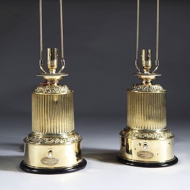 A small pair of table lamps. Patent colza oil originally now powered by electricity. Very crisp repousse brass