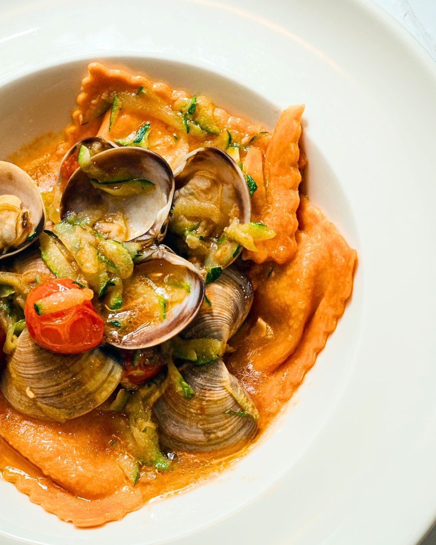You can almost hear the little tomato whispering, &quot;I could've been ketchup, but here I am. Luckily, on something a bit m ore delicious!&quot;

Seabass ravioloni with clams. What else? ❤️