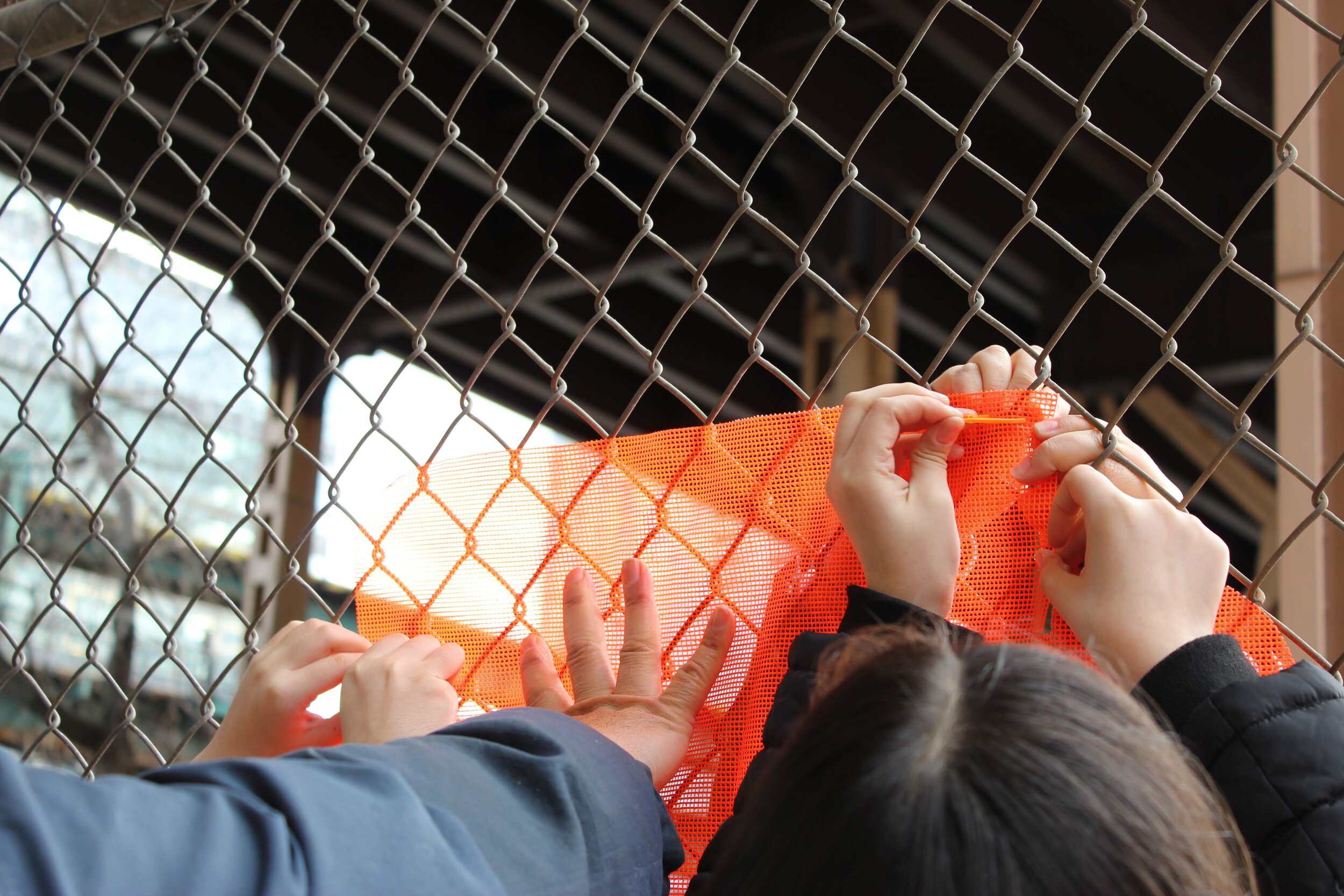 Hands peicing together the students mural