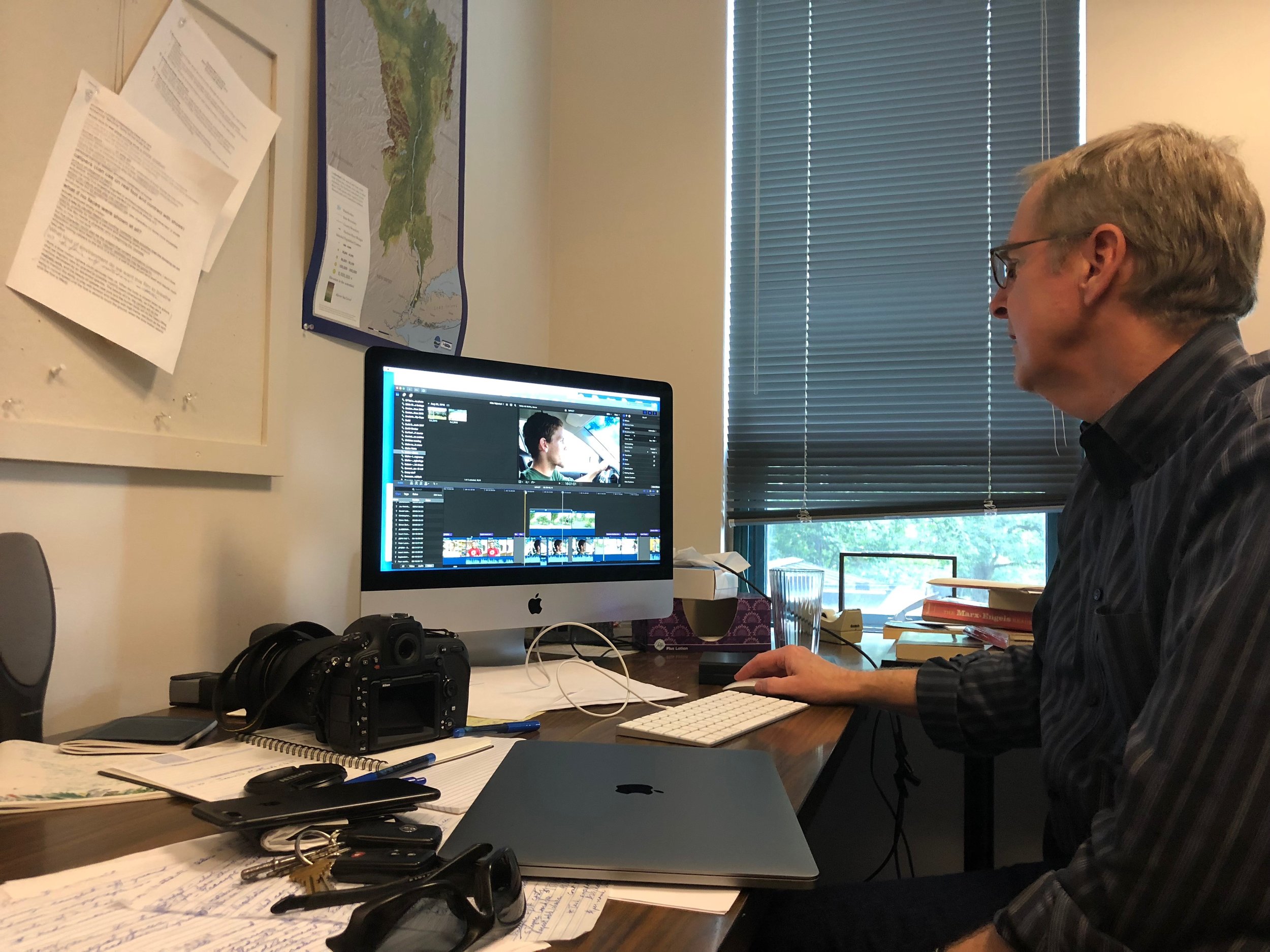 Professor Scarce editing ‘Impact’ at his desk.