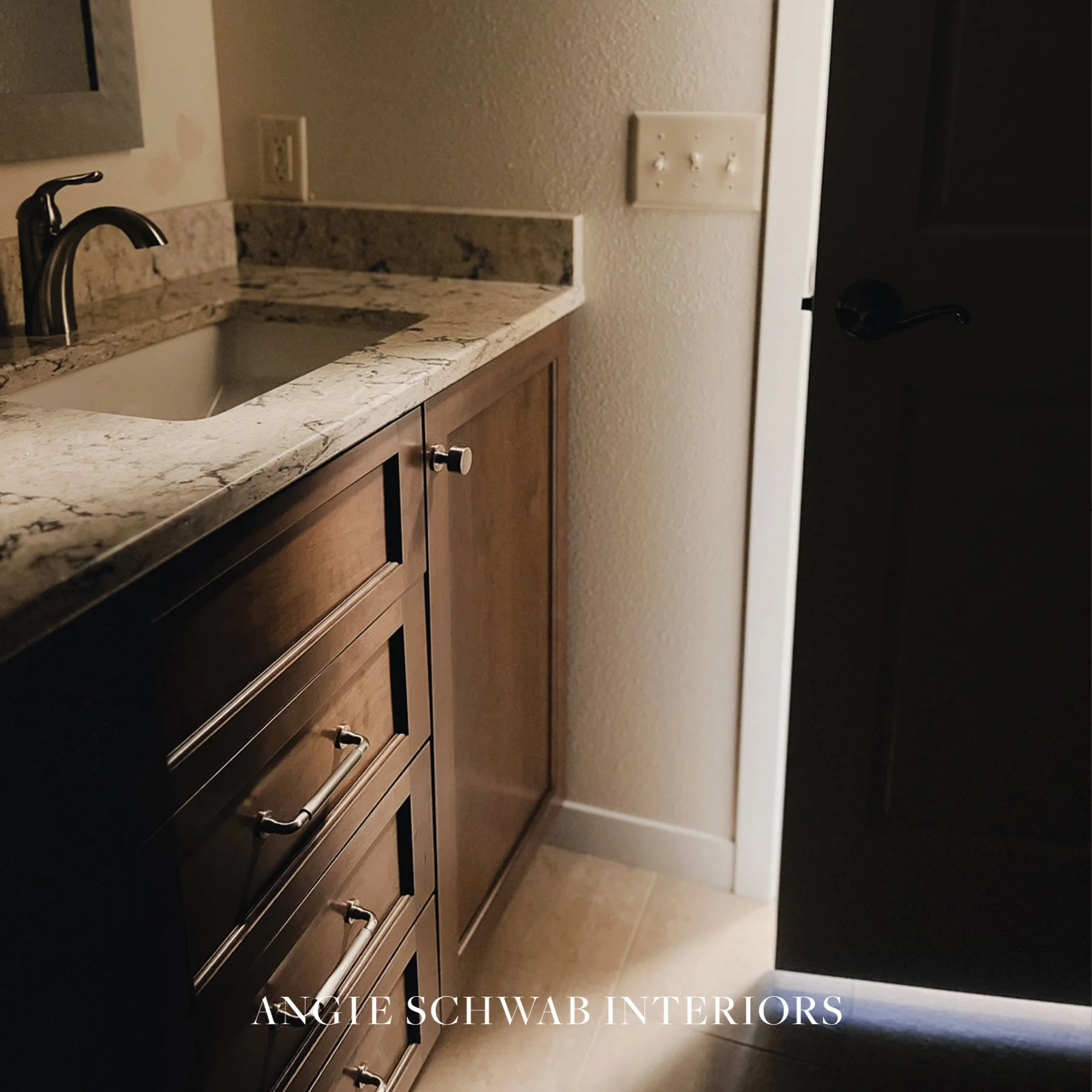 Warm wood cabinetry, layered finishes, and hardware that looks substantial &mdash; every element thoughtfully selected to create a bathroom that feels both refined and livable.

Interior Design | Madison WI | Bathroom Remodel