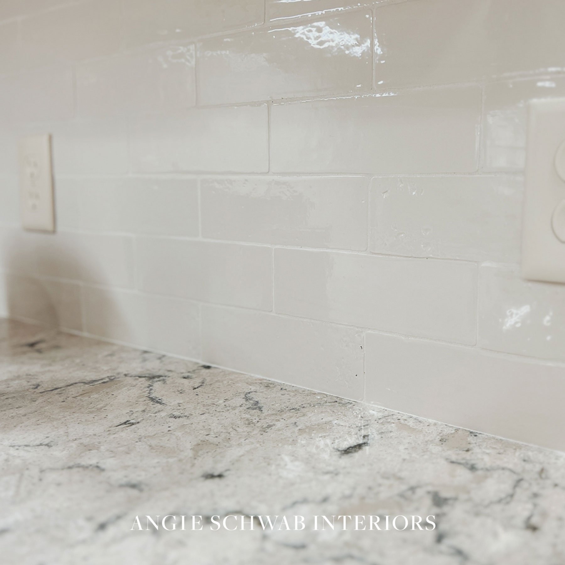 The subtle variation and soft sheen in this tile keep it from feeling flat or overly stark, while the warm undertones pair beautifully with the movement in the countertop. The result is classic, bright, and inviting &mdash; without feeling cold.

Som