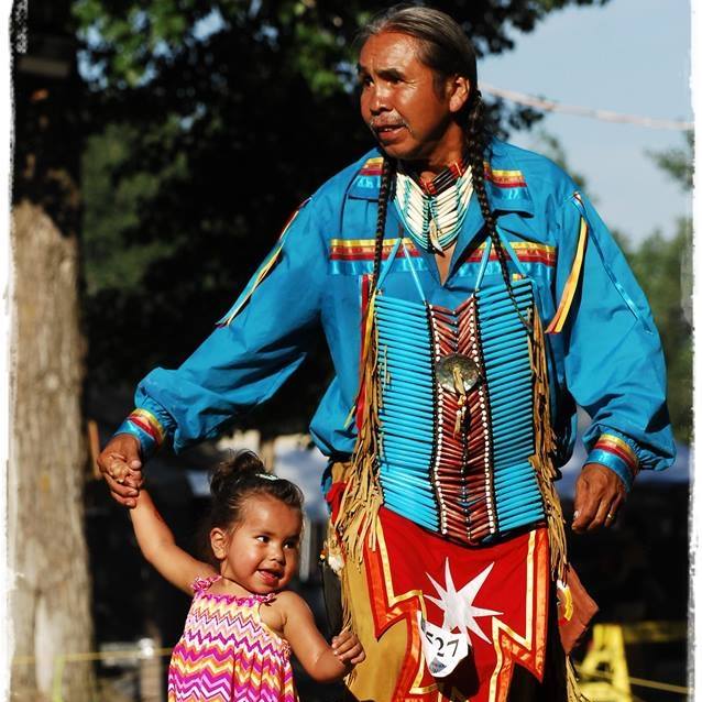 Delbert Sampson, Residential School Survivor, at a Pow Wow with his granddaughter