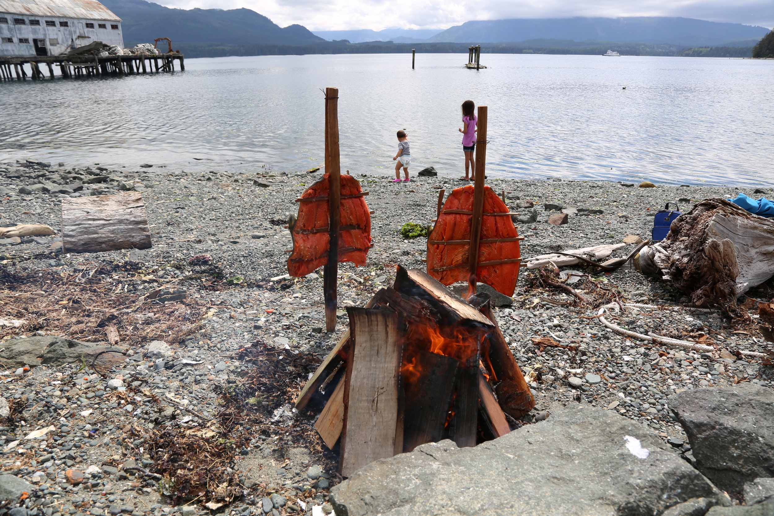 My daughter and god daughter playing on the beach of Alert Bay, BC while we prepare sockeye salmon for a family dinner.