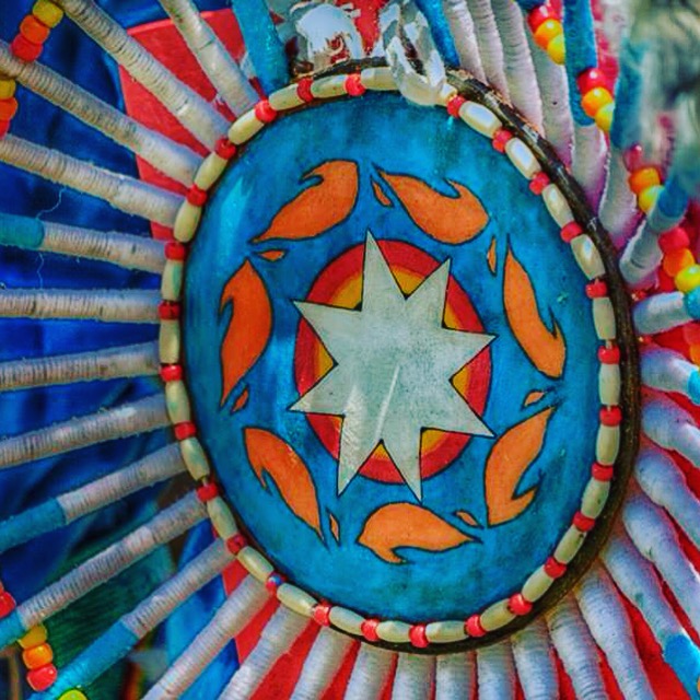 Delbert Sampson's bustle, an adapted version of the TRC fire logo to represent surviving through his schooling so he can proudly dance for all of those children who didn't make it and the people still fighting.