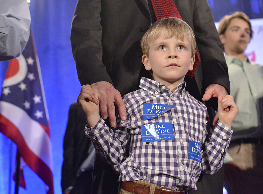Grandson of Ohio Attorney General Mike DeWine, 4 year old Parker, celebrates his grandfathers reelection with his father and family at the Ohio G.O.P. watch party in Columbus on election night, Nov. 4, 2014. Original story available at kentwired.com
