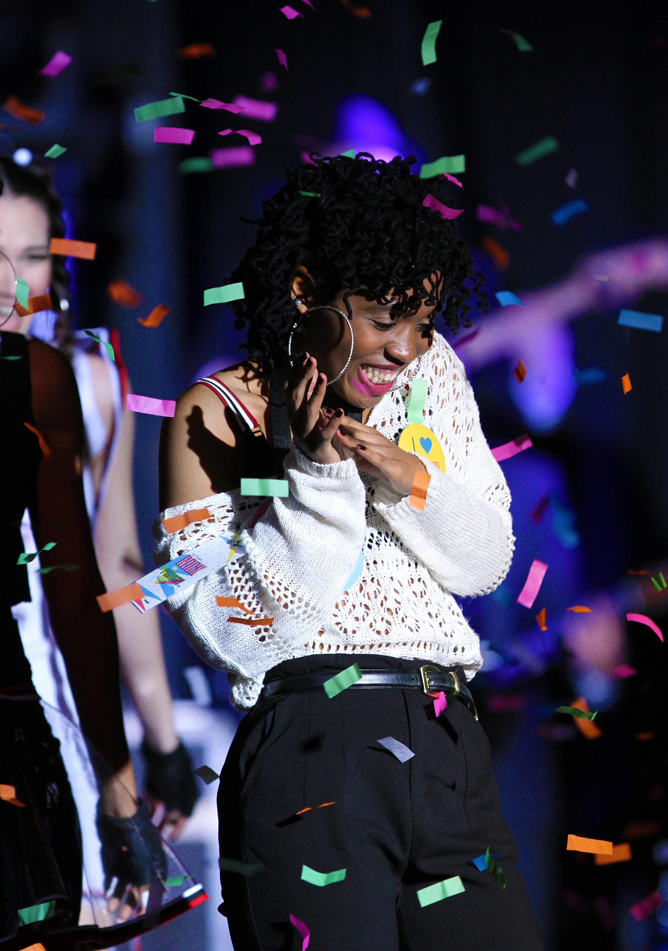 Sophomore fashion design major Asia Parker, designer of the outfits for the group "A Simple Power," celebrates winning Kent State's Rock the Runway fashion show on March 7, 2015. Parkers collection featured a unique use of plastic as well as the cohesive use of colors, patterns, and large hoop earnings on all her models. 