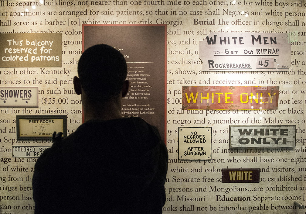 Kenny Jenkins, a communication studies major at Kent State University, stops and stares at a wall inside the Jim Crow Museum of Racist Memorbilia that displays segregation signs and laws created during the Jim Crow Era on Sept 19, 2014. The list of laws, a small sample of thousands, was compiled by the Martin Luther King Jr. National Historic site interpretive staff. Original story available at kentwired.com