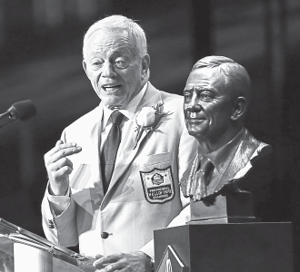 Dallas Cowboys owner Jerry Jones speaks next to his bust at the Pro Football Hall of Fame.