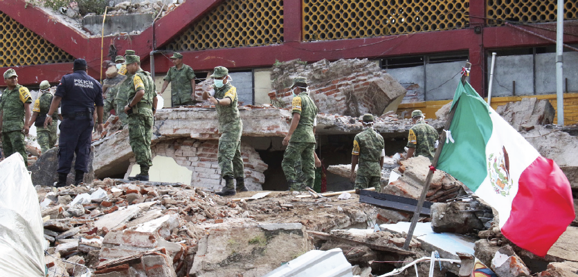 Soldiers remove debris from a partly collapsed municipal building felled by a massive earthquake in Juchitan, Oaxaca state, Mexico, Friday, Sept. 8.