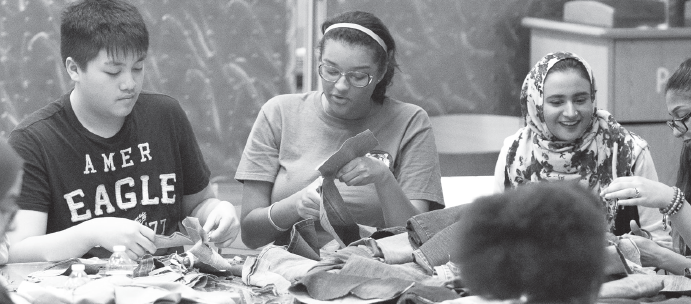 eddy Nguyen (left), Zoë Randle, Amina, Amal Azab and classmates turn jeans into shoes.
