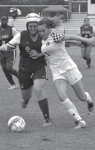 Eva Mulligan shields the ball away from a Blinn college defender on Sept. 10.