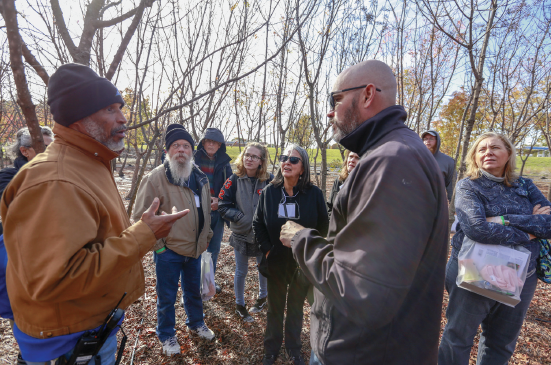 Matt Grubisich, right, leads a tour of the tree farm during the Sustainability Summit Nov. 9.