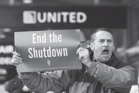 Several dozen federal employees and supporters demonstrated at the Sacramento International Airport calling for President Donald Trump and Washington lawmakers to end the partial government shutdown, Jan. 16, in Sacramento, Calif.
