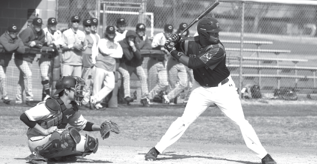 Kwamae Byers keeps his eye on the ball, waiting for the perfect pitch during the game against Cedar Valley on Feb 21.
