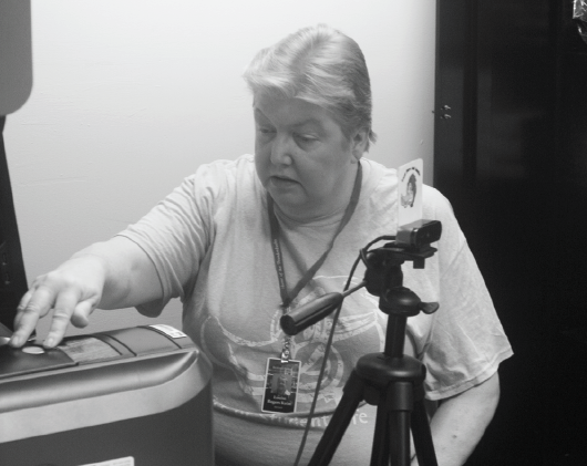 Louise Rogers Keim prints badges in preparation for April 1 deadline.