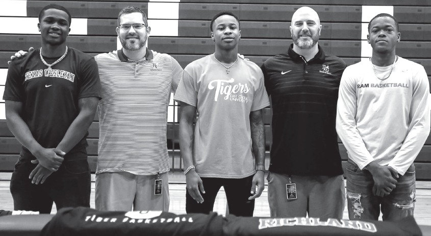Davon Berry, left, Coach Brian Graham, Caleb Williams, Coach Jon Havens and David Shepard at signing day on April 30.
