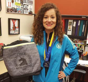 Rosalia Baker with medal and race swag.
