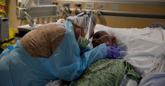 Romelia Navarro, 64, weeps while hugging her husband, Antonio, in his final moments in a COVID-19 unit at St. Jude Medical Center in Fullerton, Calif., on July 31, 2020.