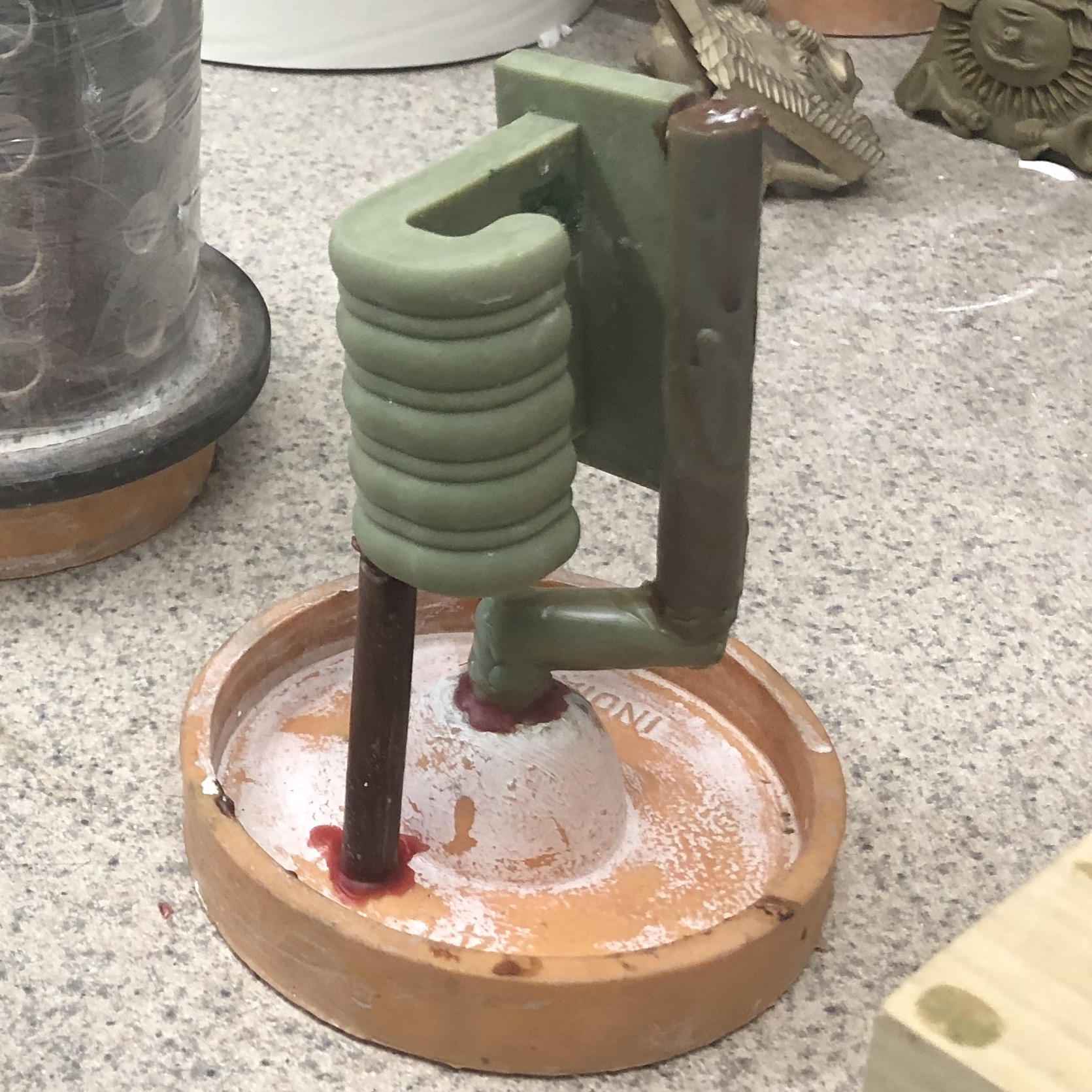 3. The wax casting, having been removed from the silicone mold, is shown here supported by wax sprues. The sprues become the path for the metal to be poured into the part, and for the air to escape.