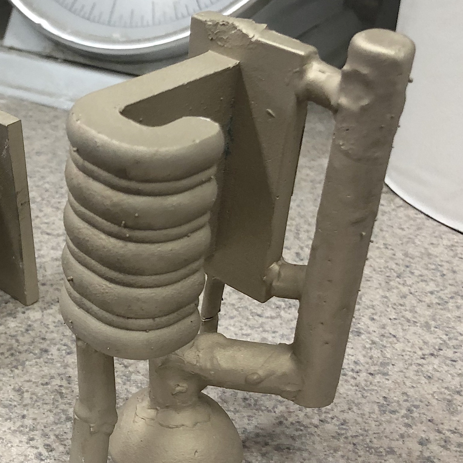 9. The sprues fill with metal, as does the part itself. They are removed when the casting has fully cooled.