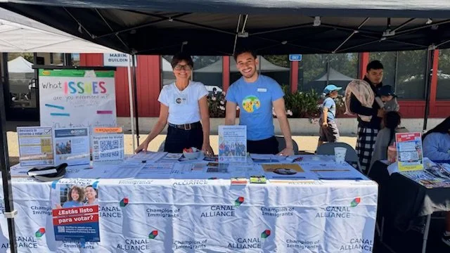 Sara Thorpe from LWVMC and Pedro Moreira from Canal Alliance register voters, answer questions and GOTV at the canal alliance small business marketplace event Sunday, May 17.