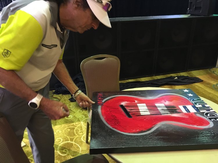  Alice Cooper signing a Hendon for Saint Jude Hospital. 