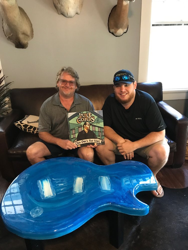  Luke Combs receiving a hand-crafted furniture piece by Hendon.  