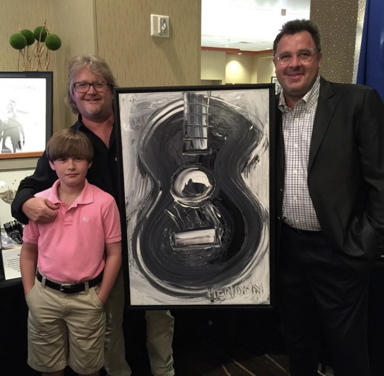 Singer-songwriter and musician, Vince Gill, with his Hendon painting