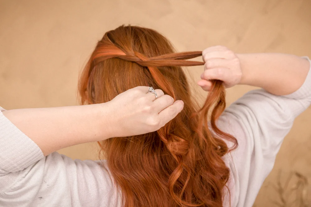 Braid one side from top to bottom, making sure to divide your three sections for the braid about 2-3 inches away from the front to avoid part lines.