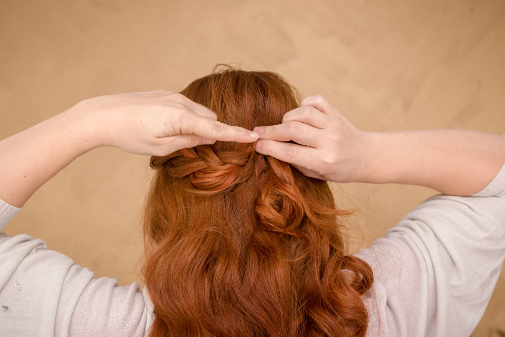 Secure section with two bobby crossing bobby pins a few inches below the crown in center of head.