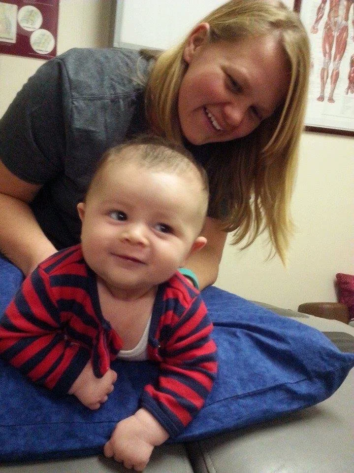 Baby smiling with Dr. Iman smiling checking his pelvis.